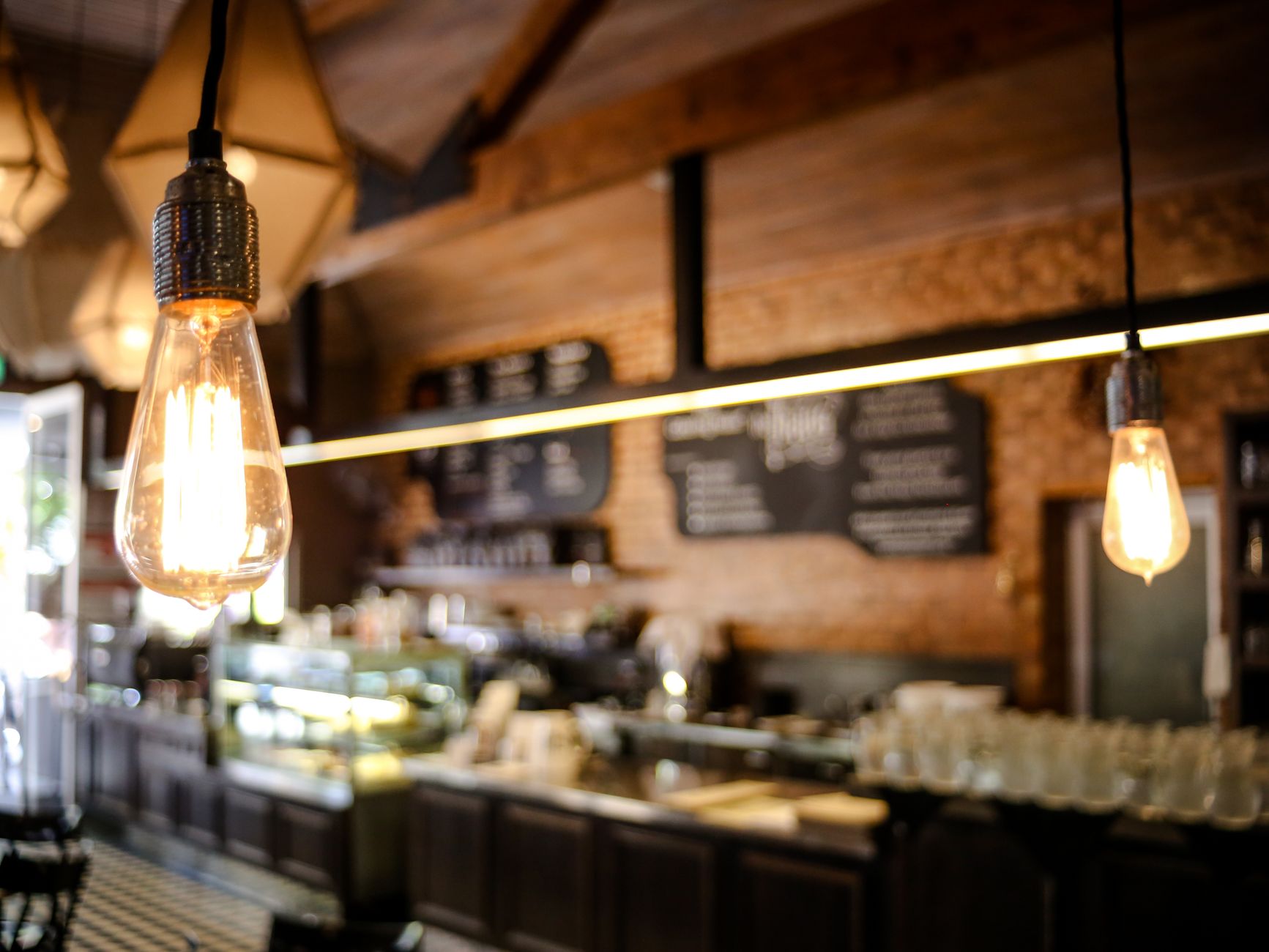 Warm interior lighting over a wooden bar counter